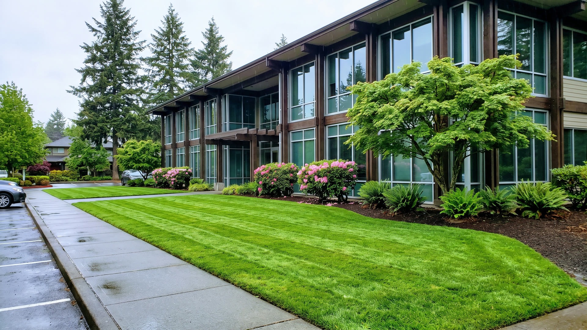 The same commercial property after ManageMowed: striped turf and clean beds